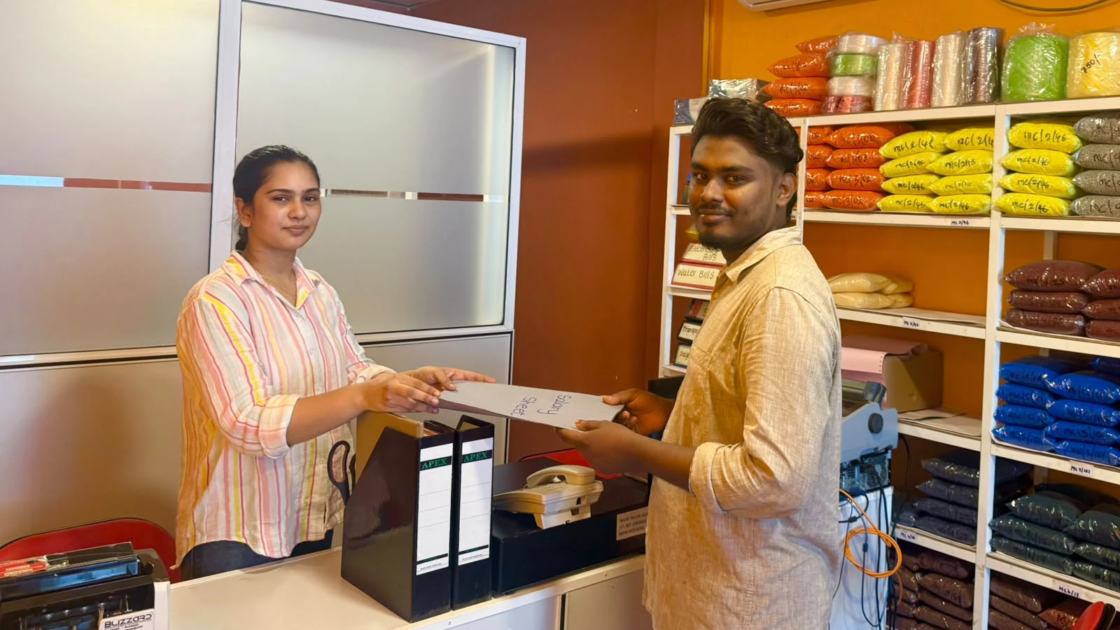 Mundiyan office staff assisting a customer
